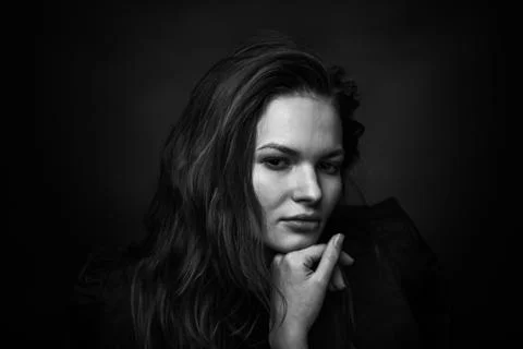Dramatic black and white portrait of a beautiful girl on a dark background Foto stock