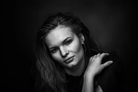 Dramatic black and white portrait of a beautiful girl on a dark background Foto stock