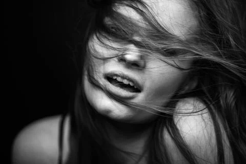 Dramatic black and white portrait of a beautiful girl on a dark background Foto stock