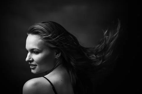 Dramatic black and white portrait of a beautiful girl on a dark background Stock Photos
