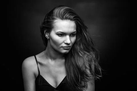 Dramatic black and white portrait of a beautiful girl on a dark background Stock Photos