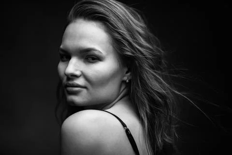 Dramatic black and white portrait of a beautiful girl on a dark background Foto stock