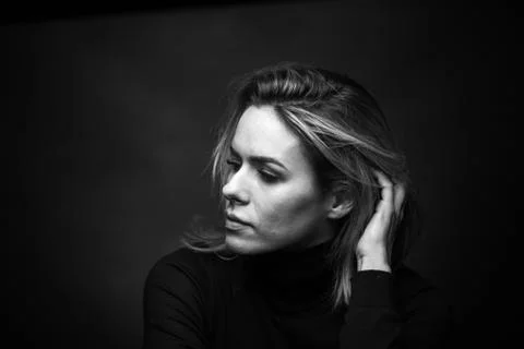 Dramatic black and white portrait of a beautiful woman on a dark background Stock Photos