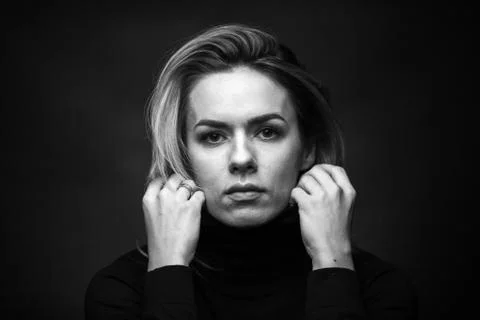 Dramatic black and white portrait of a beautiful woman on a dark background Stock Photos
