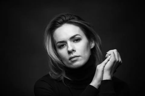 Dramatic black and white portrait of a beautiful woman on a dark background Stock Photos