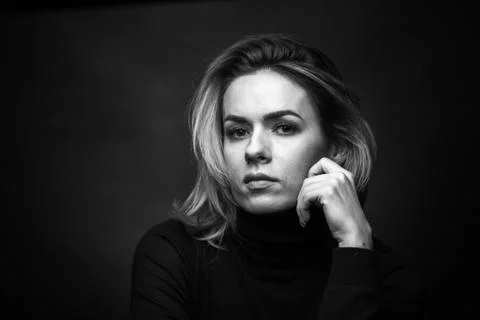 Dramatic black and white portrait of a beautiful woman on a dark background Stock Photos