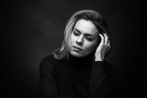 Dramatic black and white portrait of a beautiful woman on a dark background Stock Photos