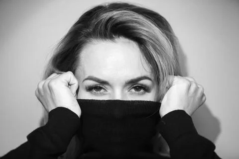 Dramatic black and white portrait of a beautiful woman on a dark background Stock Photos
