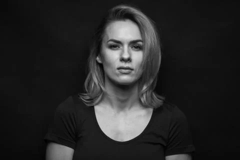 Dramatic black and white portrait of a beautiful woman on a dark background Stock Photos