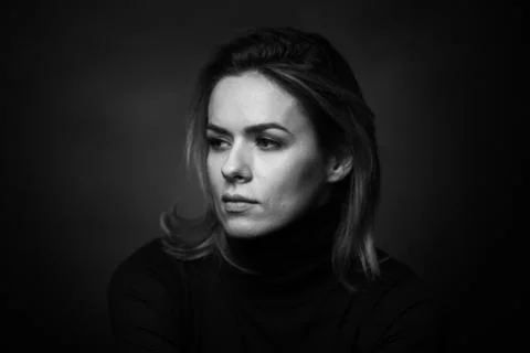 Dramatic black and white portrait of a beautiful woman on a dark background Stock Photos