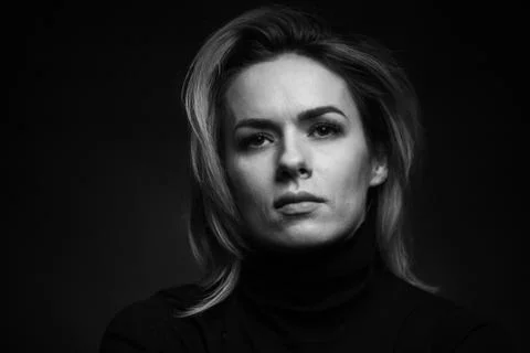 Dramatic black and white portrait of a beautiful woman on a dark background Stock Photos