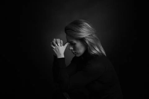 Dramatic black and white portrait of a beautiful woman on a dark background Stock Photos