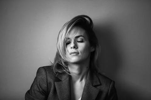 Dramatic black and white portrait of a beautiful woman on a dark background Stock Photos