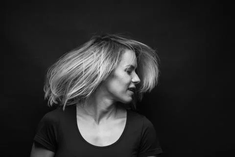 Dramatic black and white portrait of a beautiful woman on a dark background Stock Photos