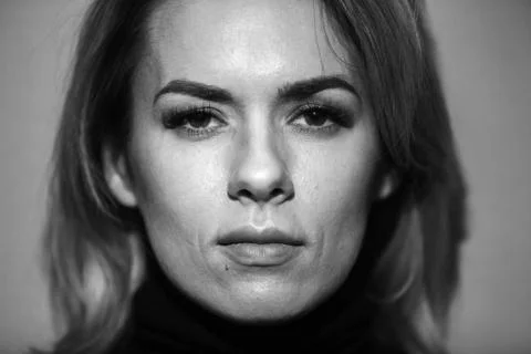 Dramatic black and white portrait of a beautiful woman on a dark background Stock Photos