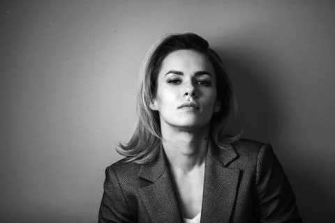 Dramatic black and white portrait of a beautiful woman on a dark background Stock Photos
