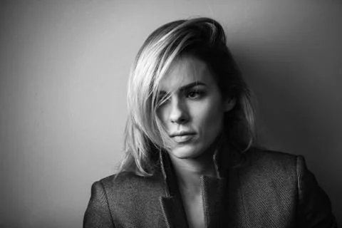 Dramatic black and white portrait of a beautiful woman on a dark background Stock Photos