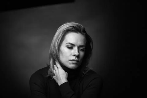 Dramatic black and white portrait of a beautiful woman on a dark background Stock Photos
