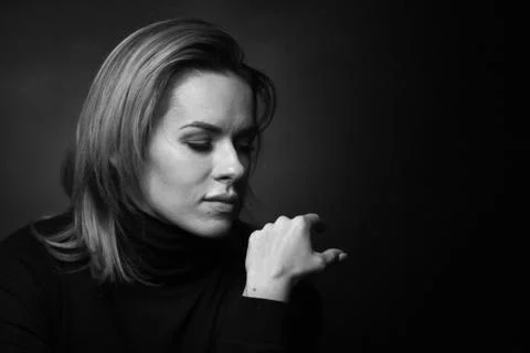 Dramatic black and white portrait of a beautiful woman on a dark background Stock Photos