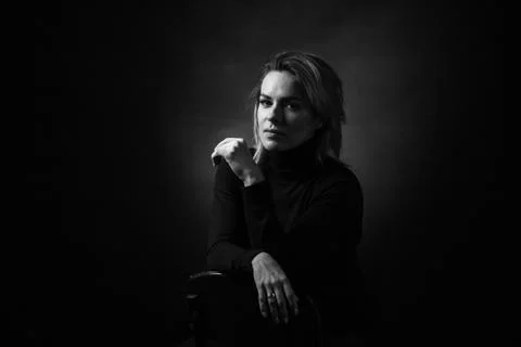 Dramatic black and white portrait of a beautiful woman on a dark background Stock Photos