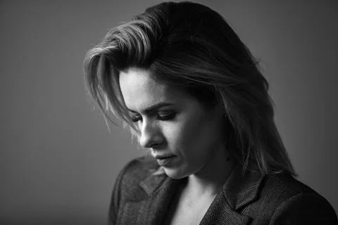Dramatic black and white portrait of a beautiful woman on a dark background Stock Photos