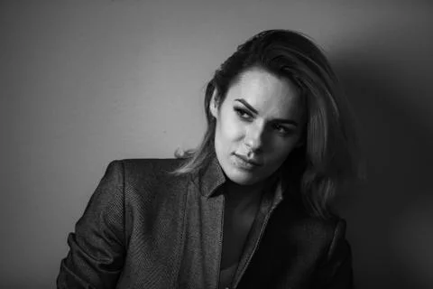 Dramatic black and white portrait of a beautiful woman on a dark background Stock Photos