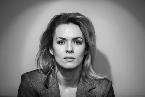 Dramatic black and white portrait of a beautiful woman on a dark background Stock Photos