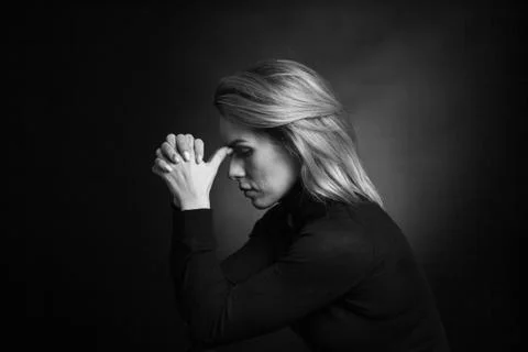 Dramatic black and white portrait of a beautiful woman on a dark background Stock Photos