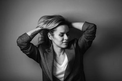 Dramatic black and white portrait of a beautiful woman on a dark background Stock Photos
