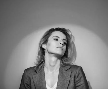 Dramatic black and white portrait of a beautiful woman on a dark background Stock Photos