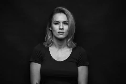 Dramatic black and white portrait of a beautiful woman on a dark background Stock Photos