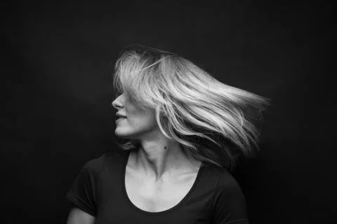 Dramatic black and white portrait of a beautiful woman on a dark background Stock Photos