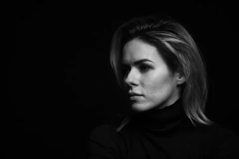 Dramatic black and white portrait of a beautiful woman on a dark background Stock Photos