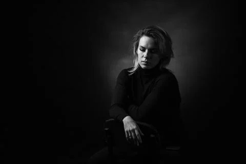 Dramatic black and white portrait of a beautiful woman on a dark background Stock Photos