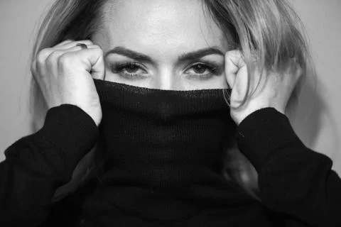 Dramatic black and white portrait of a beautiful woman on a dark background Stock Photos