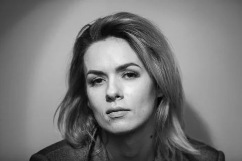 Dramatic black and white portrait of a beautiful woman on a dark background Stock Photos