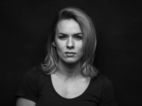 Dramatic black and white portrait of a beautiful woman on a dark background Stock Photos