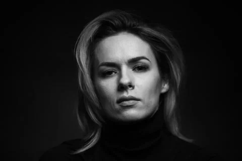 Dramatic black and white portrait of a beautiful woman on a dark background Stock Photos