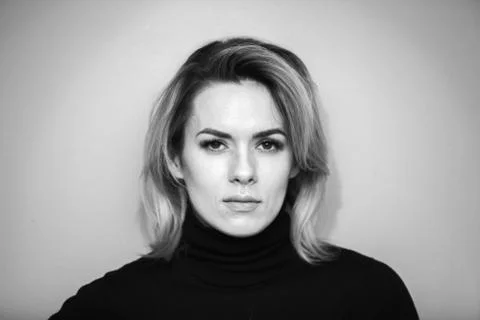 Dramatic black and white portrait of a beautiful woman on a dark background Stock Photos