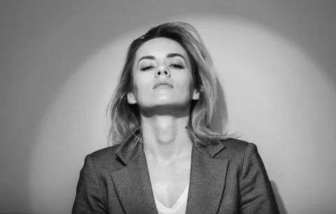 Dramatic black and white portrait of a beautiful woman on a dark background Stock Photos