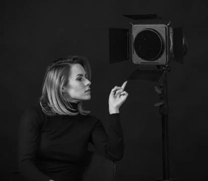 Dramatic black and white portrait of a beautiful woman on a dark background Stock Photos