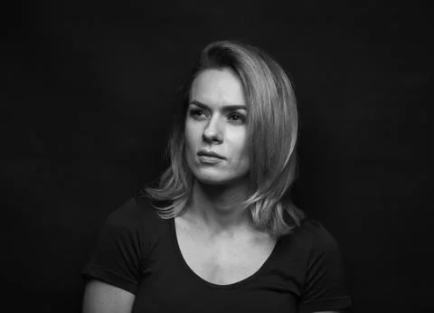 Dramatic black and white portrait of a beautiful woman on a dark background Stock Photos