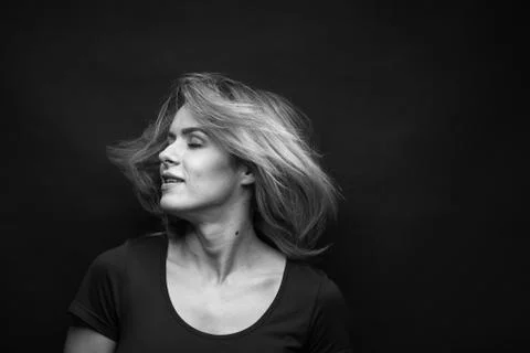 Dramatic black and white portrait of a beautiful woman on a dark background Stock Photos