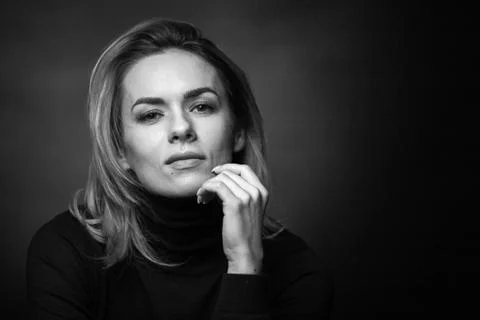 Dramatic black and white portrait of a beautiful woman on a dark background Stock Photos