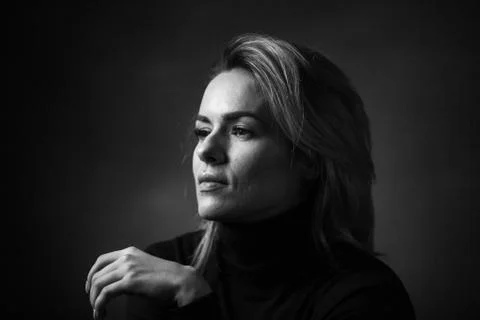 Dramatic black and white portrait of a beautiful woman on a dark background Stock Photos