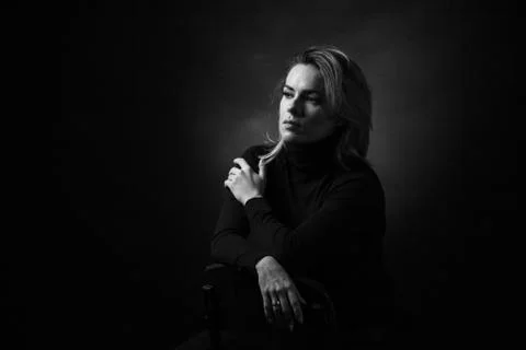 Dramatic black and white portrait of a beautiful woman on a dark background Stock Photos