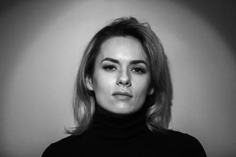 Dramatic black and white portrait of a beautiful woman on a dark background Stock Photos
