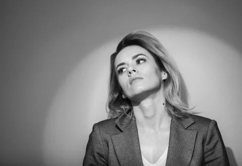 Dramatic black and white portrait of a beautiful woman on a dark background Stock Photos