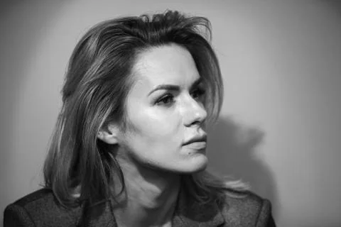 Dramatic black and white portrait of a beautiful woman on a dark background Stock Photos