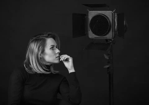 Dramatic black and white portrait of a beautiful woman on a dark background Stock Photos